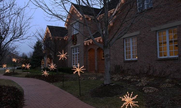 Walkway and roofline decorated with custom warm white light snowflakes