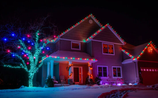 Multicolor christmas lights on house and tree