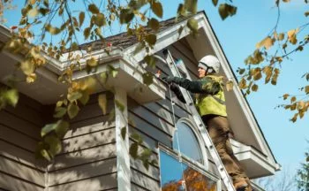 Outdoor holiday light installation on a roof/gutter line