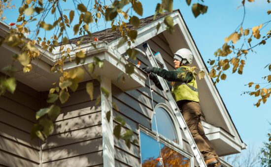 Hanging Christmas lights on a roofline safely on a ladder