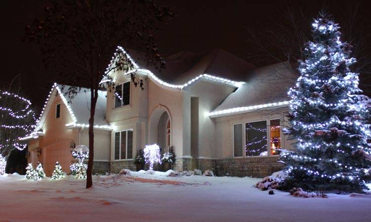 Bright white outdoor holiday lighting installation on Twin Cities home